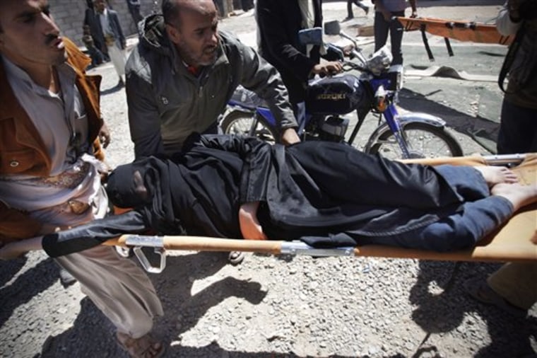 Protesters carry a wounded woman from the site of clashes with security forces in Sanaa, Yemen, on Tuesday, Oct. 18. Fighting between troops loyal to Yemen's embattled leader and rival forces on Monday killed several people, including eight supporters of a powerful tribal chief who defected to the opposition in March. 